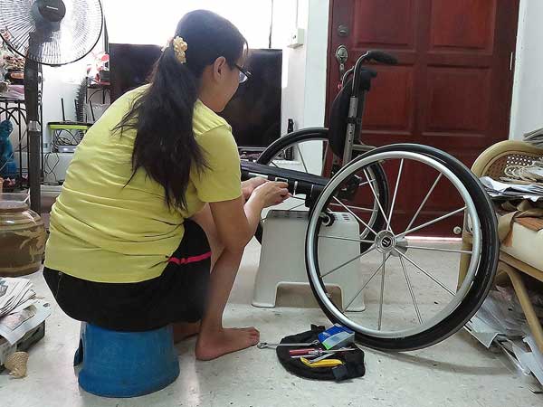 Wuan has learnt to repair my wheelchair out of necessity.