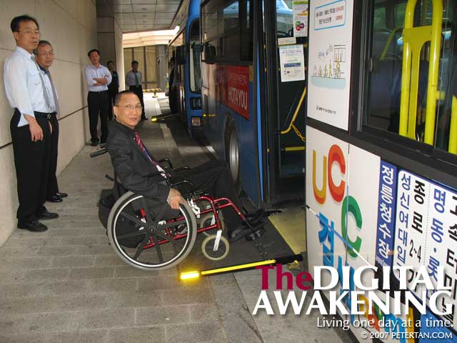Wheelchair user boarding the non-step bus